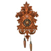Vintage wooden cuckoo clock featuring intricate carvings and a golden clock face.