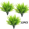 A bundle of twelve artificial green Boston ferns and faux shrubs for home decor