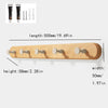 A light wood wall hook rack with four wooden hooks is shown alongside various nail and hook tools.