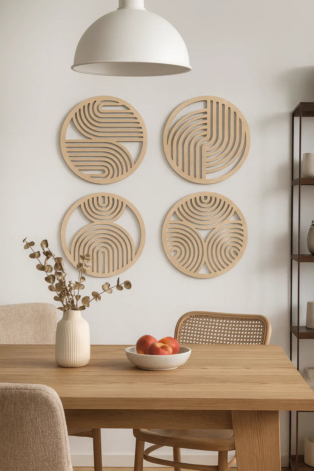A set of four round wooden wall art pieces with concentric circle patterns displayed on a white wall above a wooden table.
