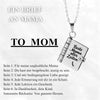 A silver pendant necklace featuring an openable book design with engraved text on the front and a heart on the back.