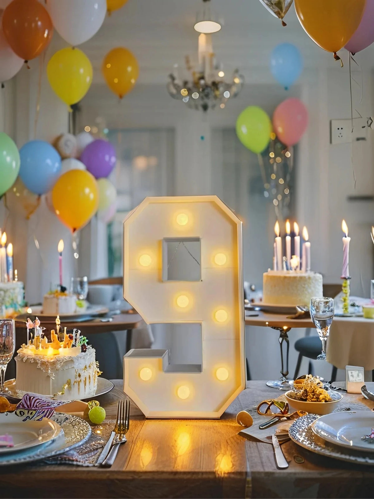A glowing LED marquee number frame shaped like the number 9 sits on a wooden table surrounded by birthday decorations and bal