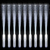 A row of fiber optic LED glow wands with light beams shining out against a dark background.