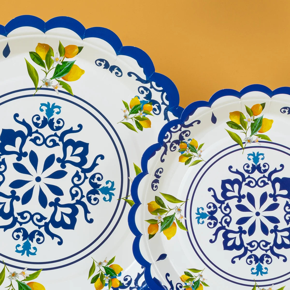 White paper plates with blue floral designs and yellow lemon accents.