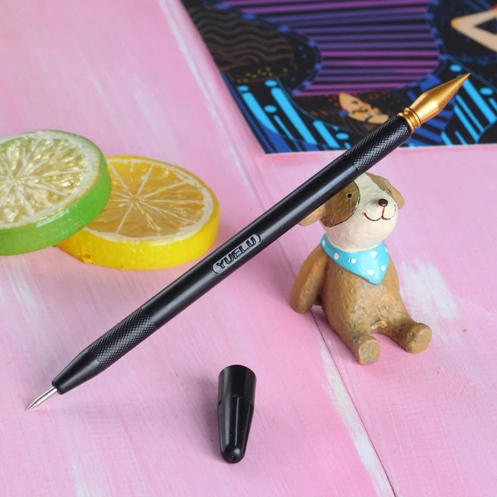 A black calligraphy pen with a gold tip rests on a pink surface next to a small stuffed animal and citrus slices.