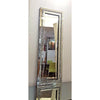 A tall silver crystal beveled wall mirror reflecting an interior room.