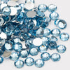 A pile of round, flatback resin rhinestones in various shades of blue and clear glass on a white background.