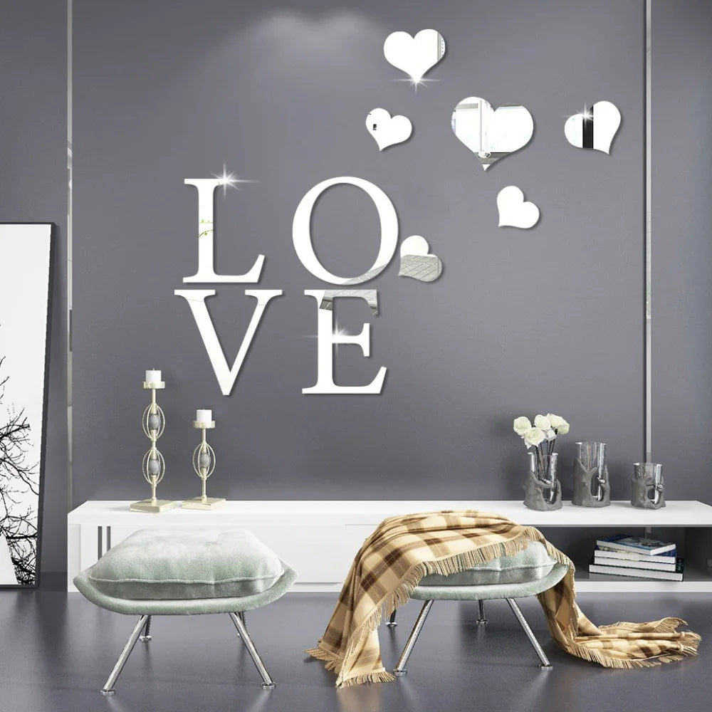 Silver acrylic heart wall stickers with a mirror finish displayed on a gray wall above a bench.