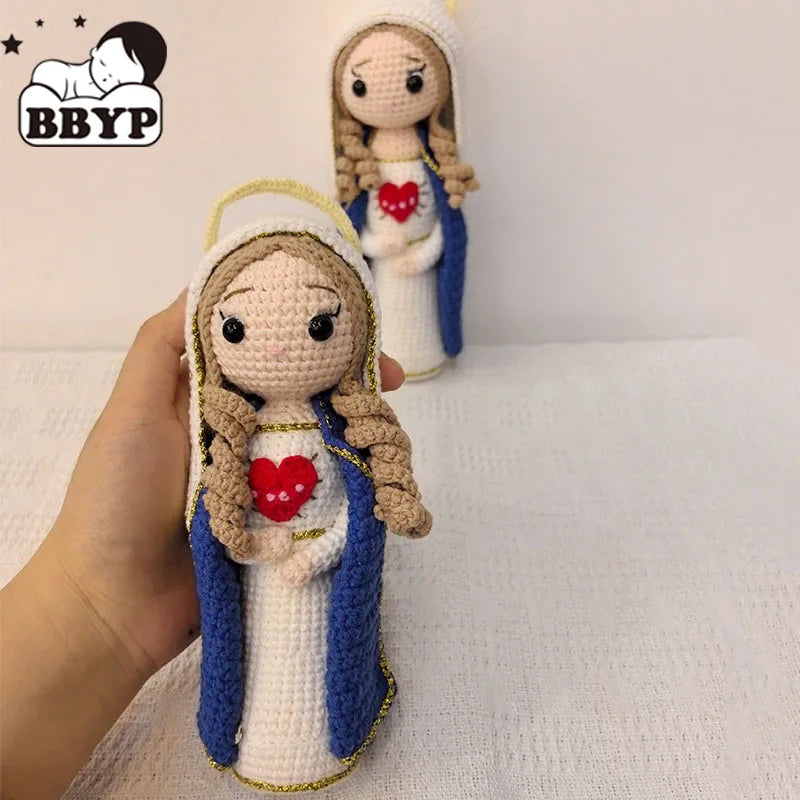Handcrafted Virgin Mary crochet doll with brown hair and blue robe holding a red heart