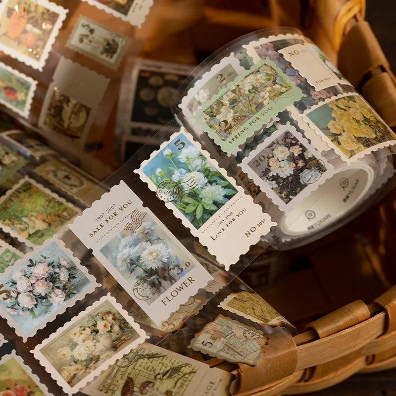 A close-up of decorative washi tape featuring floral designs and text like Sale for You Love for You and No for You in a wood