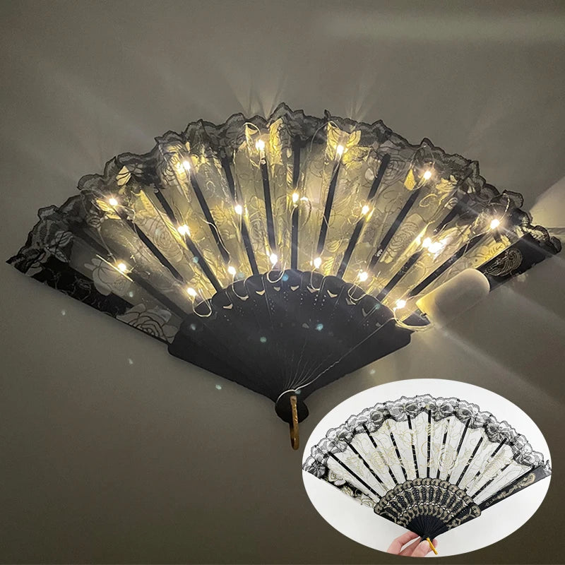 A golden LED dancing hand fan with black accents is shown against a dark background.