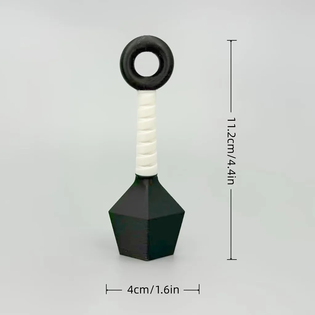A black and white ornament shaped like a dart with a ring handle.