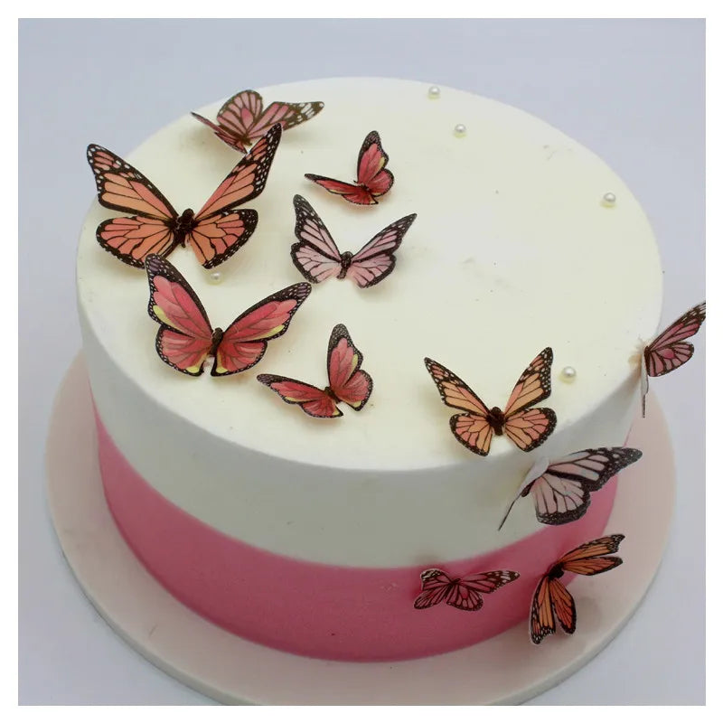 White cake decorated with pink accents and edible butterfly paper sheets for cake decorating