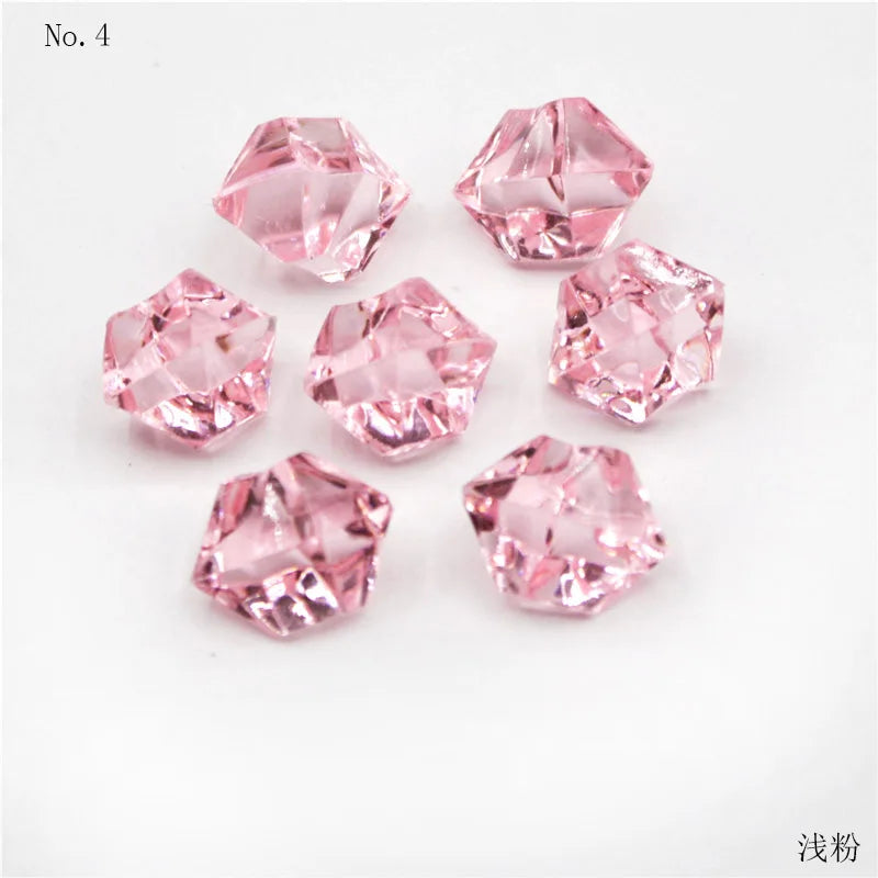 A collection of pink crystal ice cube acrylic stones arranged on a white background.