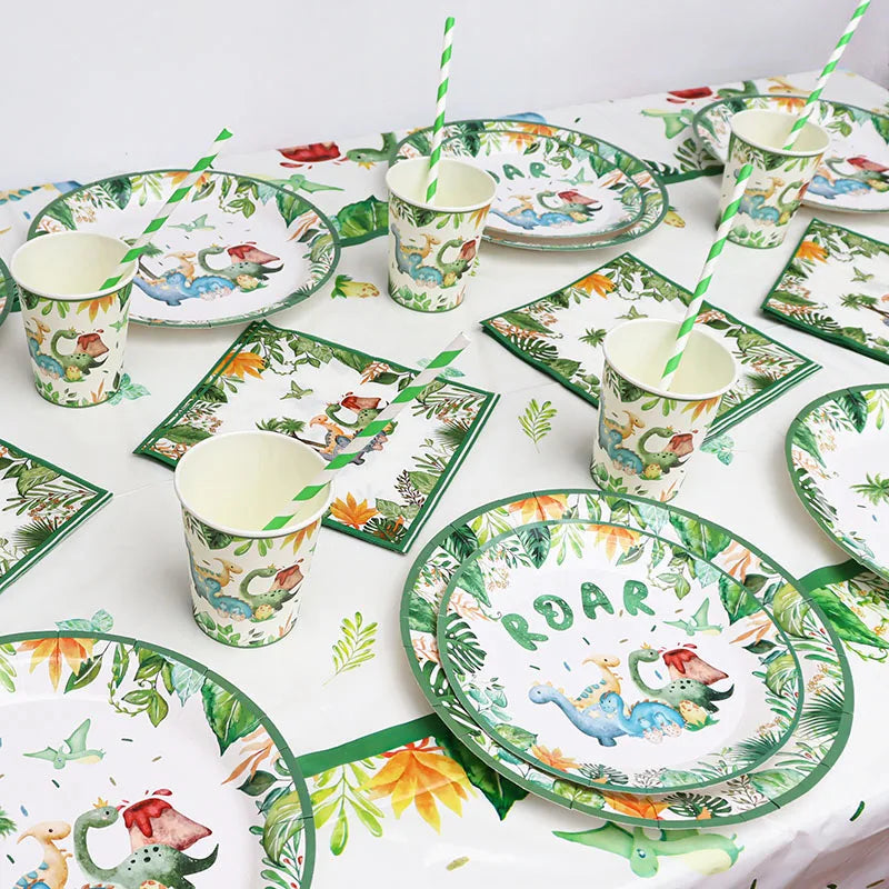 A green and white dinosaur themed disposable tableware set including plates, cups, and a banner.