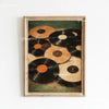 A framed canvas art print featuring a collection of vintage vinyl records in various shades of black and brown.