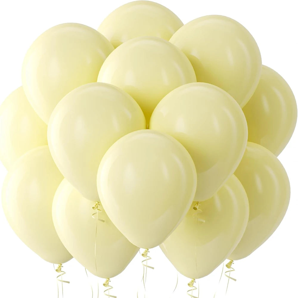 A cluster of pale yellow latex balloons floating against a white background.