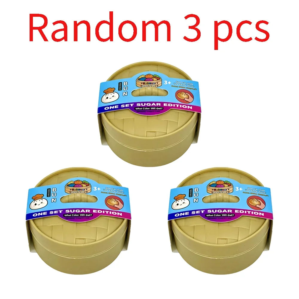 Three yellow squishy dumpling stress relief toys in packaging boxes