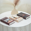 A set of three books featuring modern interior design concepts displayed on a white table with dried floral decor.