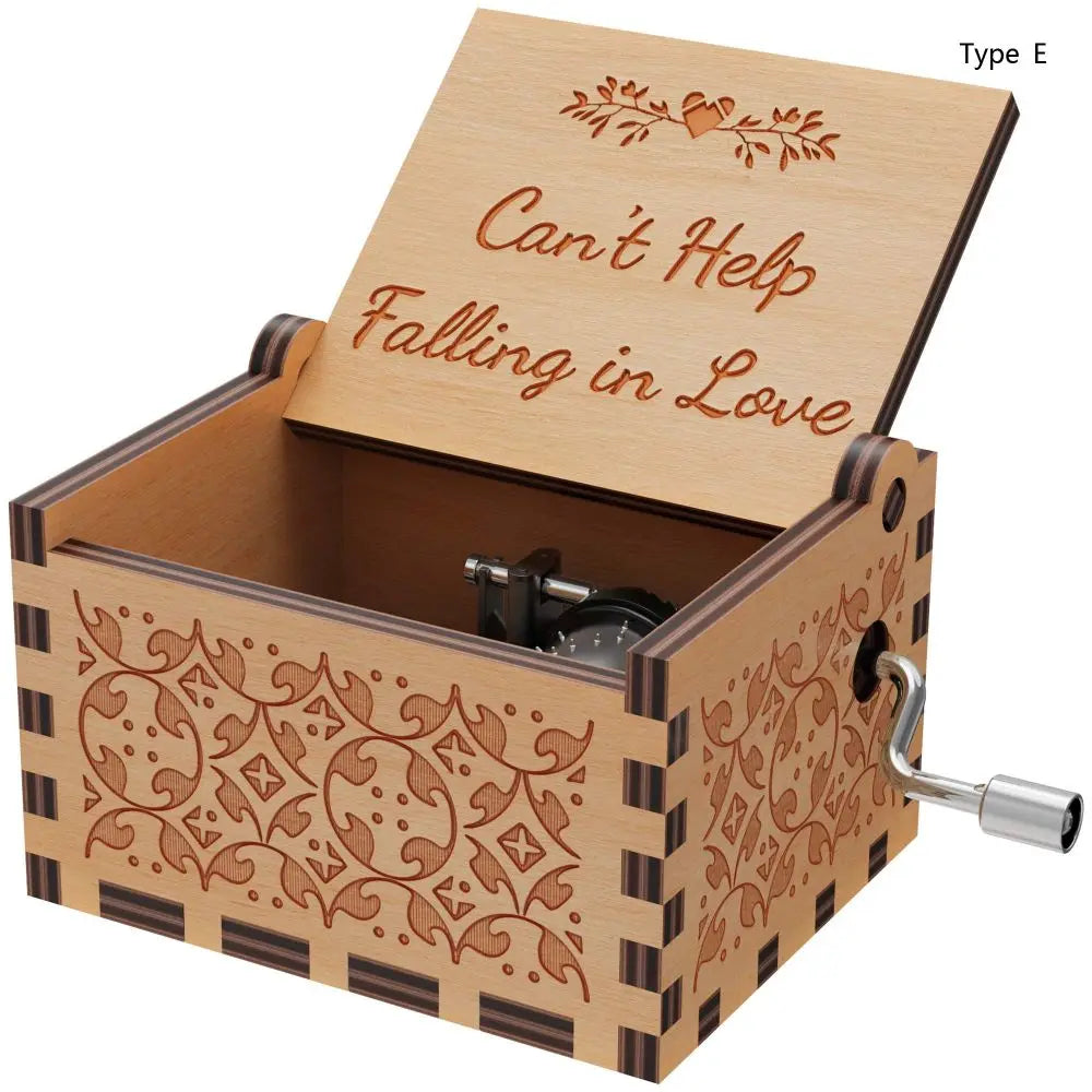 A wooden music box with a lid featuring the text Can't Help Falling in Love and decorative patterns.