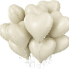 A cluster of light beige heart-shaped foil balloons tied together for a celebration.