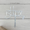 Silver acrylic birthday cake topper with gold lettering spelling out Happy Birthday