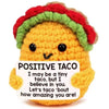 Handmade crochet baseball bat doll with a positive taco card featuring a smiling face.