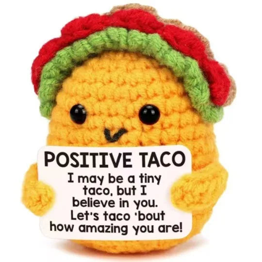 Handmade crochet baseball bat doll with a positive taco card featuring a smiling face.