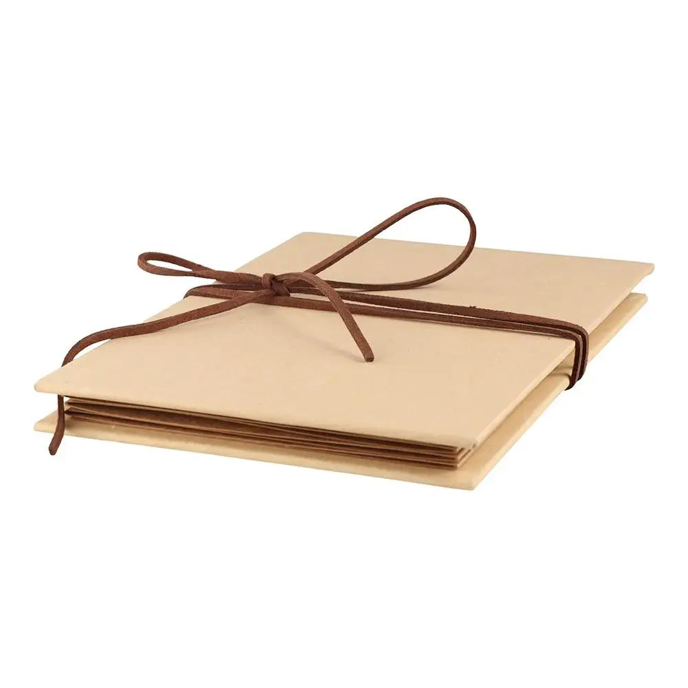 A handcrafted accordion photo album with a light tan cover tied with a brown ribbon.