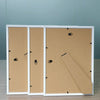 Three white picture frames with wooden fronts and acrylic borders displayed on a wooden surface.
