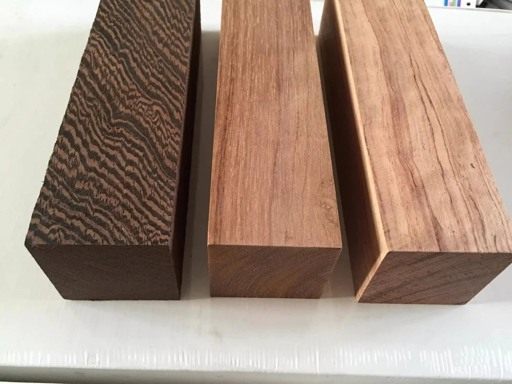 Three rectangular blocks of natural wood blanks for knife handles and DIY projects, showing different wood grain patterns.