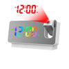 A digital alarm clock with a large LED display showing 12:00 and temperature, illuminated by a red light beam.