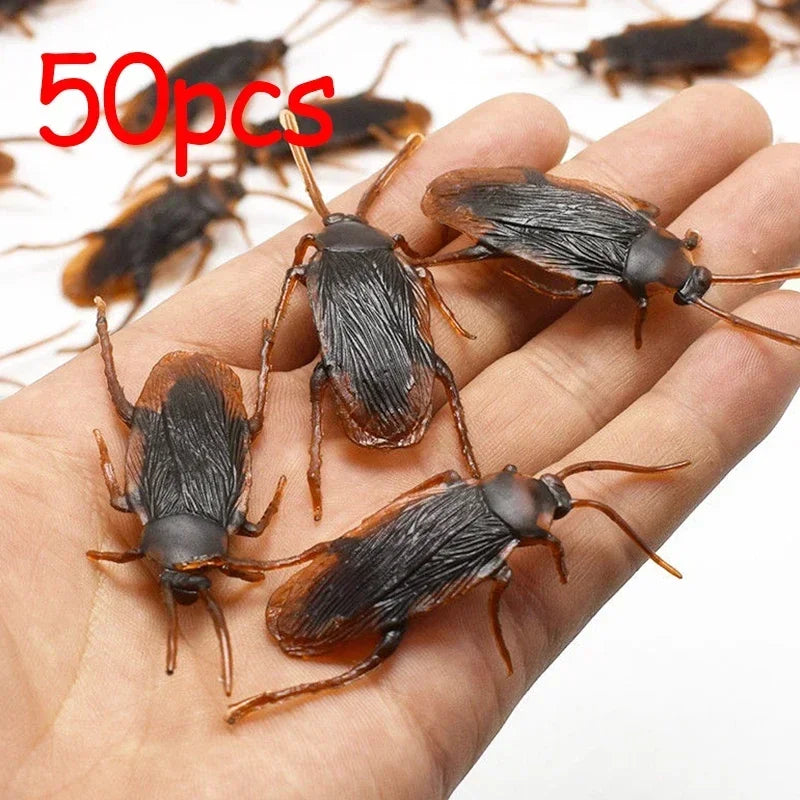 Fifty plastic cockroach gag toys are shown resting on a person's hand.