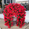 A vibrant red artificial bougainvillea vine garland decorating a porch in wintery outdoor setting.