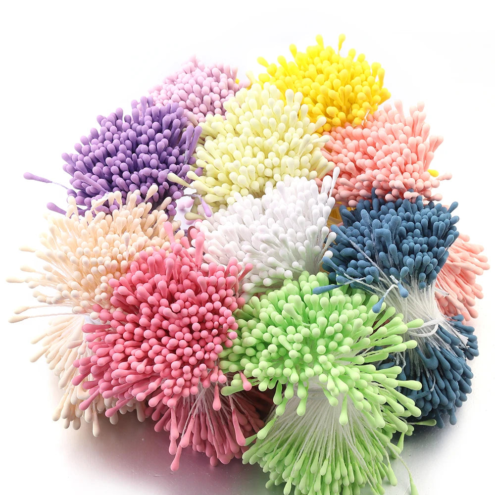 A cluster of mini artificial flower stamens in various shades including purple, yellow, pink, and green.