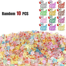 A pile of 10 small, colorful resin duck charms in various shades of yellow, pink, and clear.
