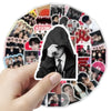 A hand holds a circular sticker pack featuring various BT21 characters and designs.