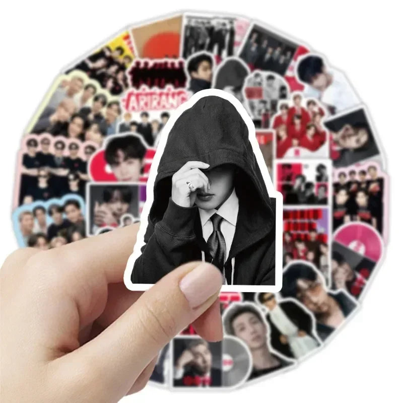 A hand holds a circular sticker pack featuring various BT21 characters and designs.