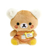 A cute brown bear plush toy with white ears and an orange bag pendant.