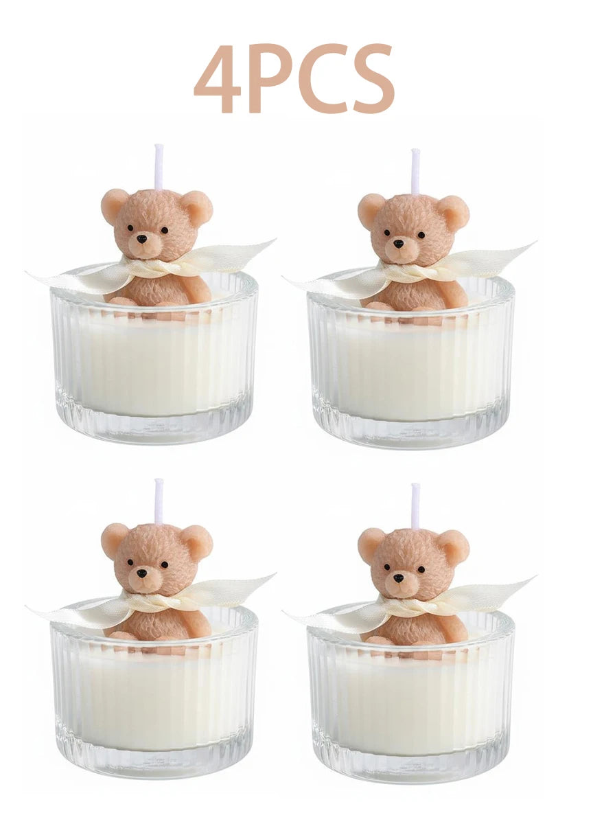 Four soy wax teddy bear candles in glass jars with ribbon
