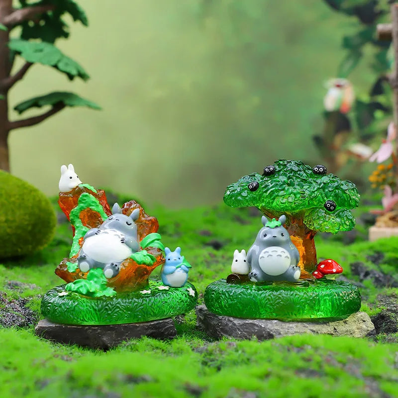 A blind box featuring small ceramic animal figures like a white rabbit and a gray hedgehog set in a mossy green landscape.