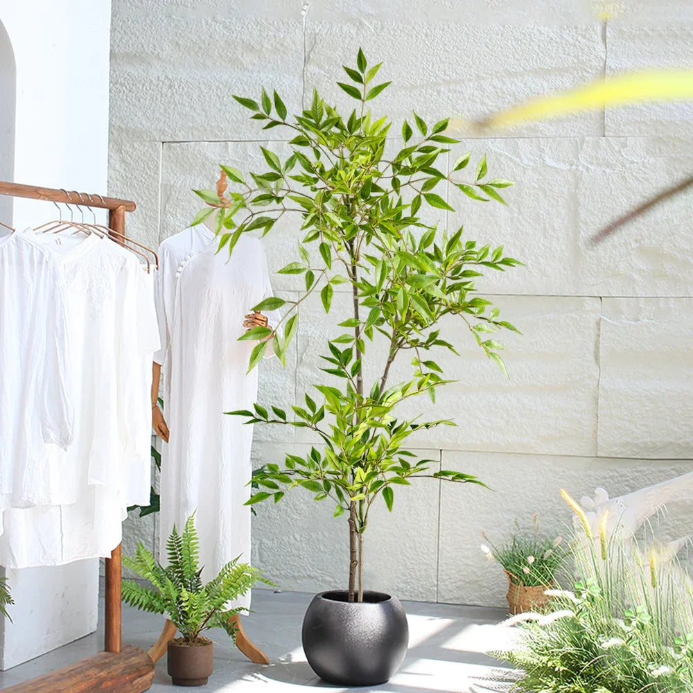 A tall artificial Nandina plant with bright green leaves in a dark pot displayed indoors.