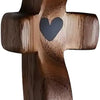 A dark brown wooden comfort prayer cross with a heart carved into the center.