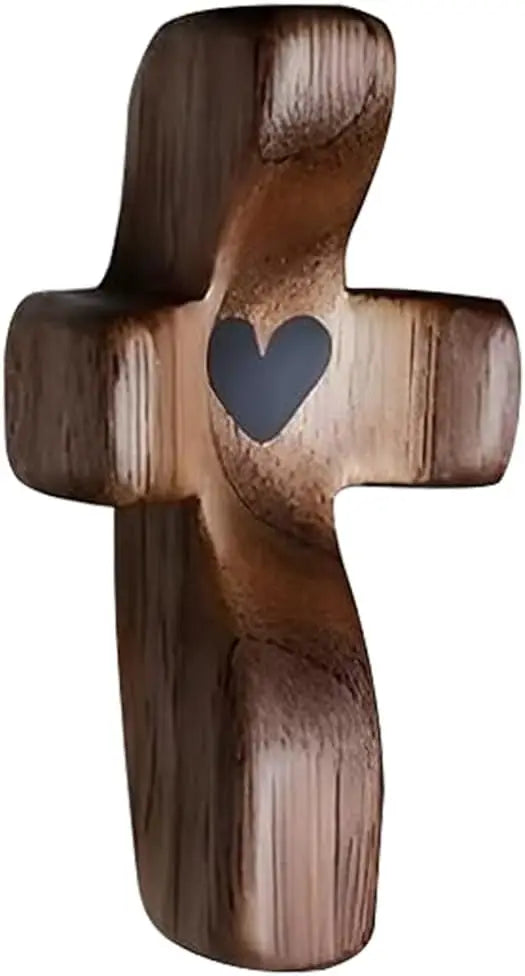 A dark brown wooden comfort prayer cross with a heart carved into the center.