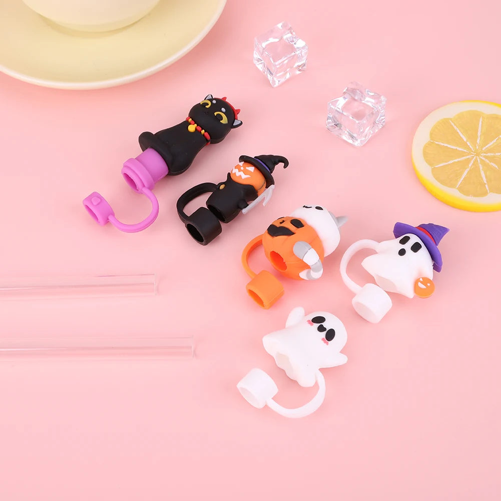 Reusable silicone straw covers shaped like Halloween cats and a lemon on a pink background