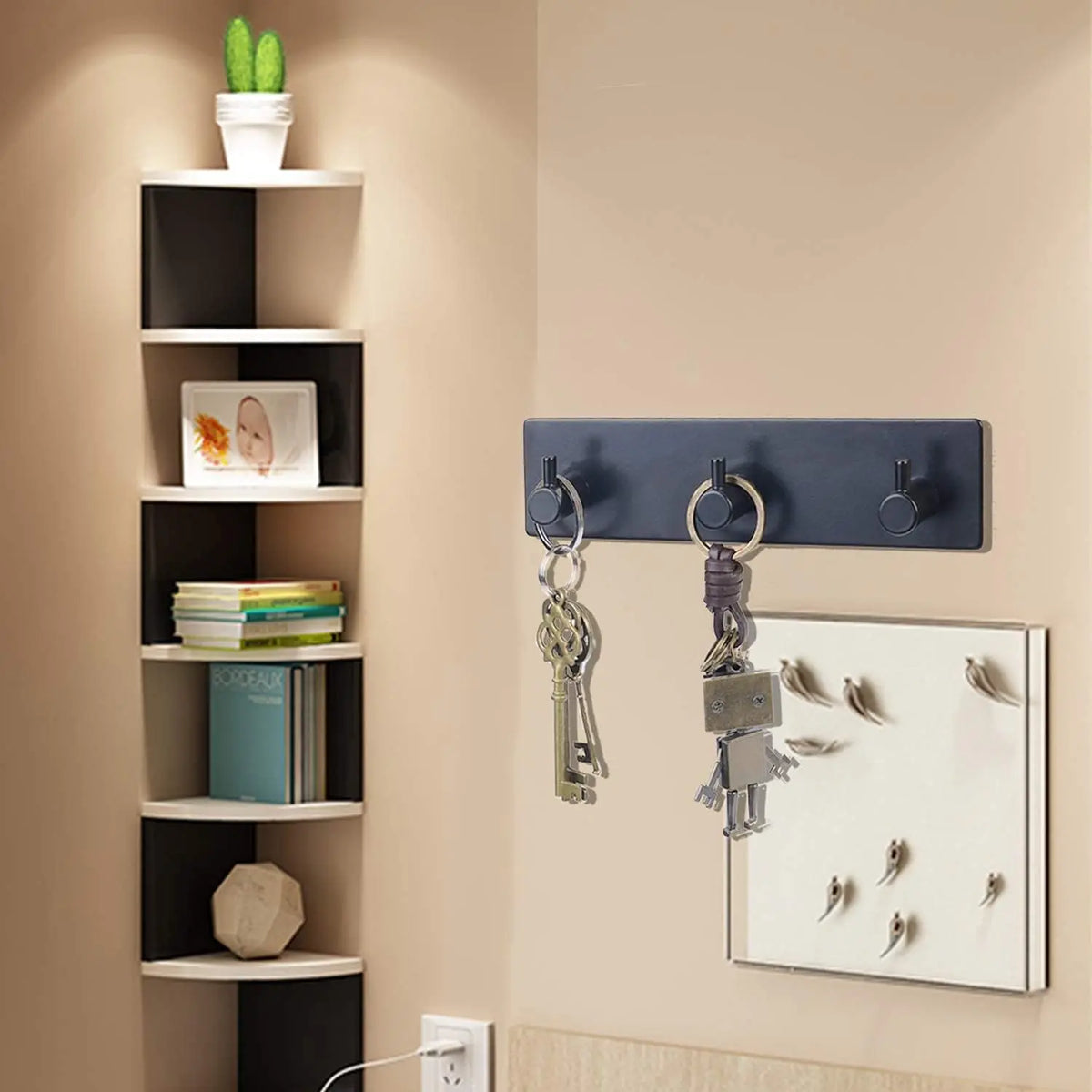 A dark wall shelf displaying various hooks for keys and jewelry on a beige wall.