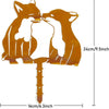 A rustic wrought iron cat Halloween fence ornament featuring two cats facing each other.