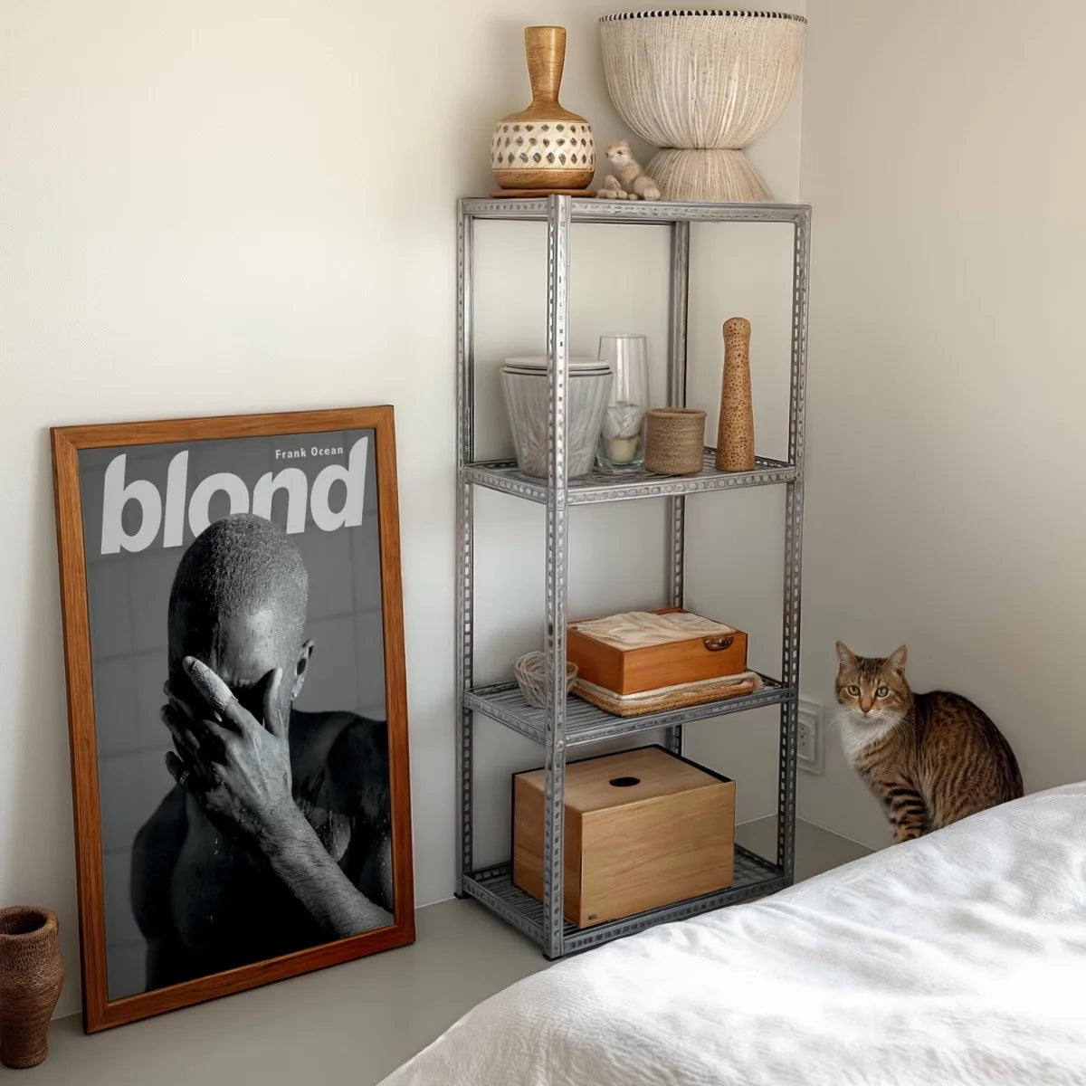 A canvas print featuring a black and white portrait of Frank Ocean's head and hand, displayed next to a metal shelving unit.