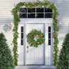 Green Norfolk pine Christmas garland with optional lights decorating a white door.