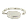 Silver foldable handbag hook designed for use on tables and desks.